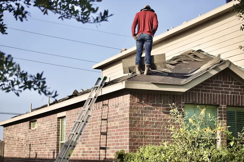 Professional roofer working on a residential roof in Secane
